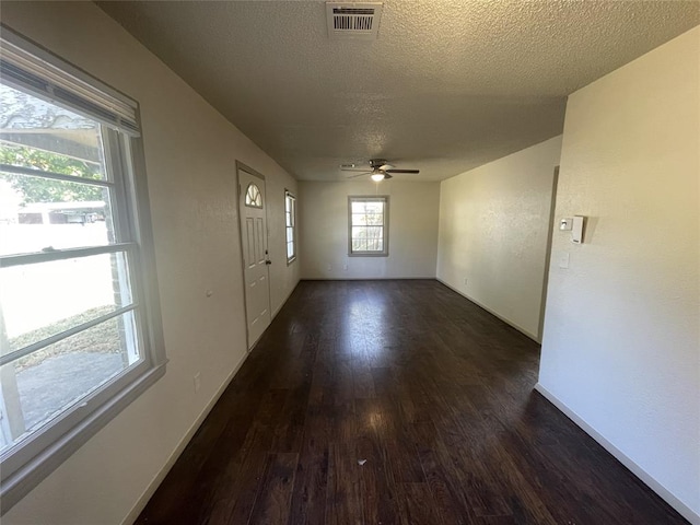 interior space featuring a textured ceiling, dark hardwood / wood-style floors, and ceiling fan