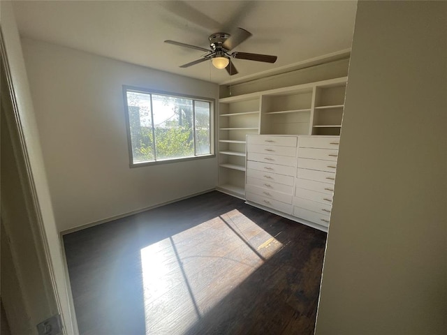 unfurnished bedroom with ceiling fan, a closet, and dark hardwood / wood-style floors