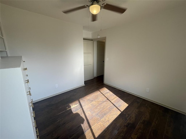 spare room featuring dark hardwood / wood-style floors and ceiling fan