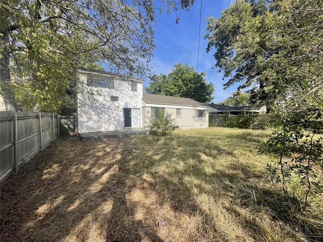 back of house with a lawn