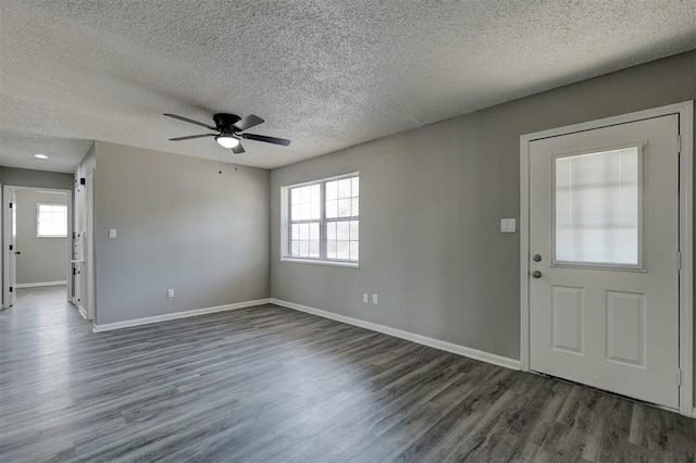 entrance foyer with ceiling fan, dark wood-type flooring, and a textured ceiling