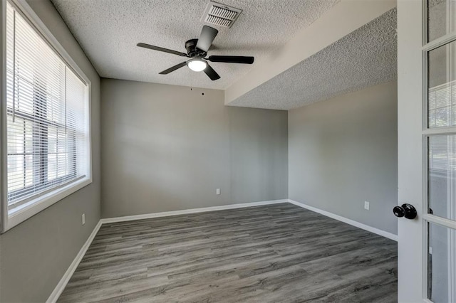 empty room featuring hardwood / wood-style floors, plenty of natural light, and ceiling fan