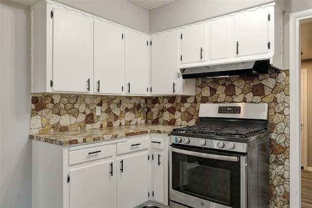 kitchen featuring white cabinets, backsplash, and stainless steel range with gas stovetop