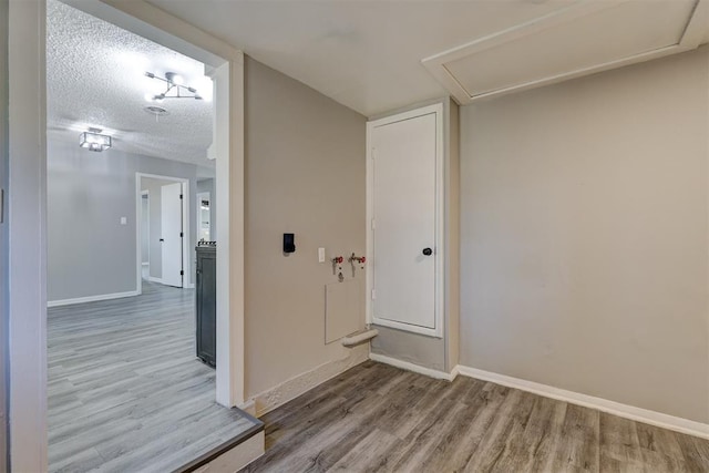 interior space featuring hardwood / wood-style flooring and a textured ceiling