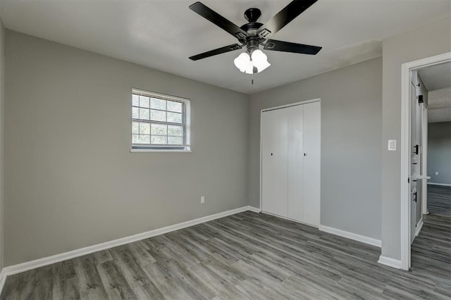 unfurnished bedroom with a closet, light hardwood / wood-style flooring, and ceiling fan