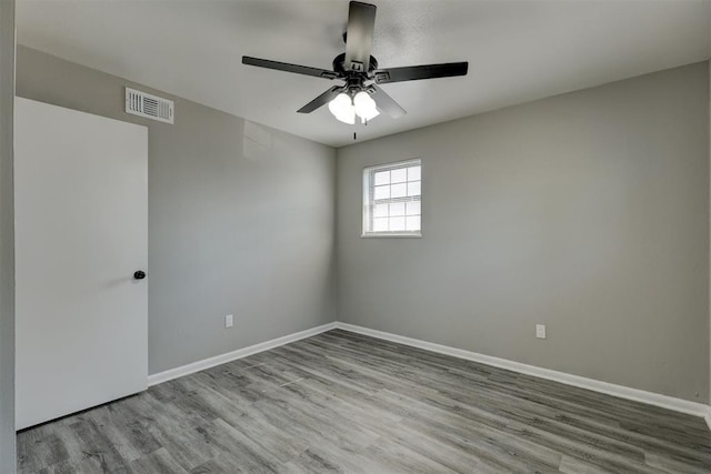 spare room featuring ceiling fan and light hardwood / wood-style floors