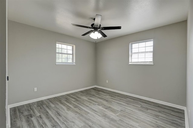 unfurnished room with ceiling fan, light hardwood / wood-style floors, and a textured ceiling