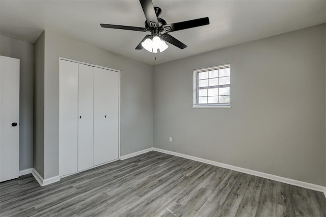 unfurnished bedroom featuring ceiling fan, light hardwood / wood-style flooring, and a closet