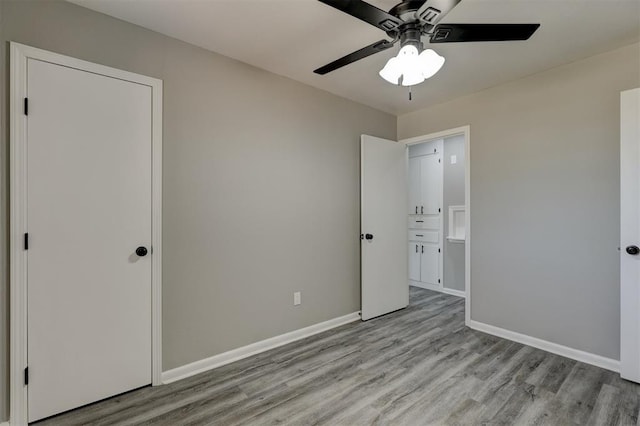 unfurnished bedroom featuring ceiling fan and light wood-type flooring