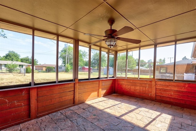 unfurnished sunroom with ceiling fan