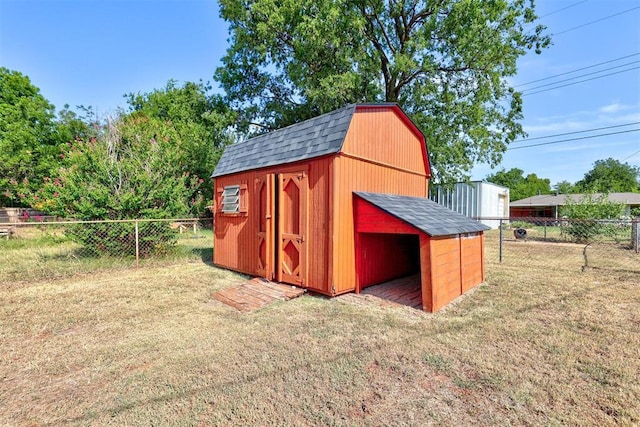 view of outbuilding with a yard