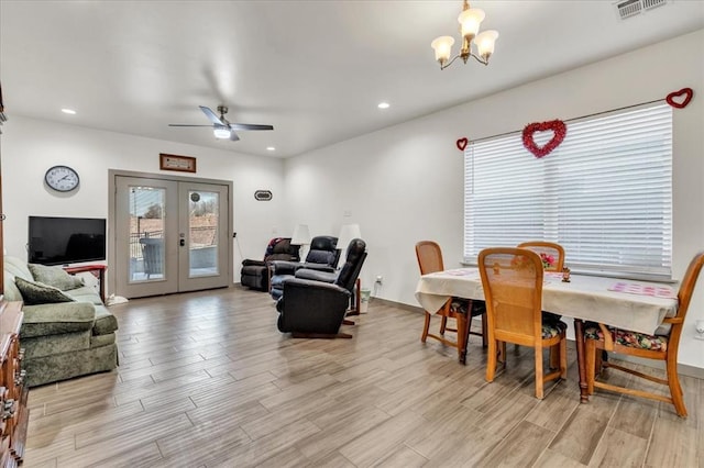1305 Katelyn Ct, Yukon, OK 73099 - dining room with light wood-style floors, a chandelier, french doors, recessed lighting, and a ceiling fan