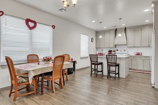 1305 Katelyn Ct, Yukon, OK 73099 - dining room featuring light wood-type flooring, recessed lighting, and a chandelier