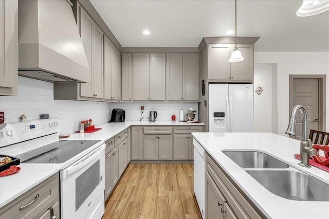 1305 Katelyn Ct, Yukon, OK 73099 - kitchen with white appliances, wall chimney exhaust hood, gray cabinets, light wood finished floors, and hanging light fixtures