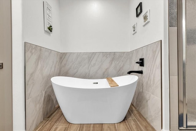 1305 Katelyn Ct, Yukon, OK 73099 - bathroom with tile walls, a soaking tub, and wainscoting