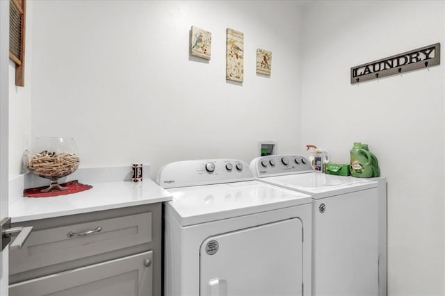 laundry room with cabinets and separate washer and dryer