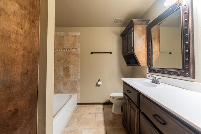 bathroom featuring toilet, vanity, and a washtub