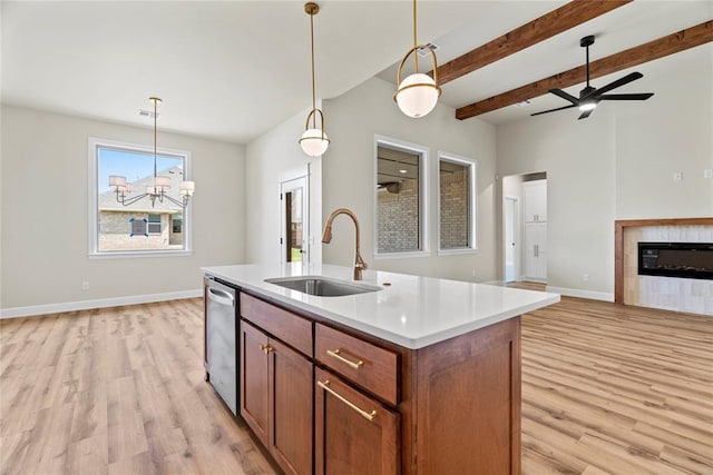 kitchen with dishwasher, sink, light hardwood / wood-style flooring, a center island with sink, and ceiling fan with notable chandelier