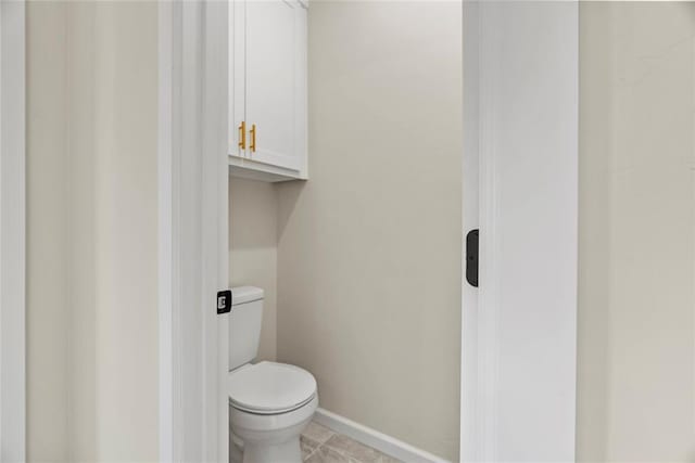 bathroom featuring tile patterned flooring and toilet