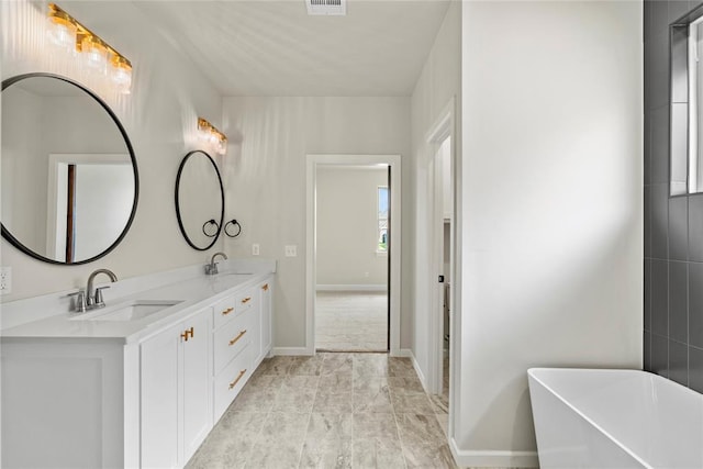 bathroom with vanity and a tub to relax in