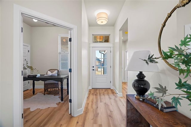 foyer entrance featuring baseboards and light wood-type flooring