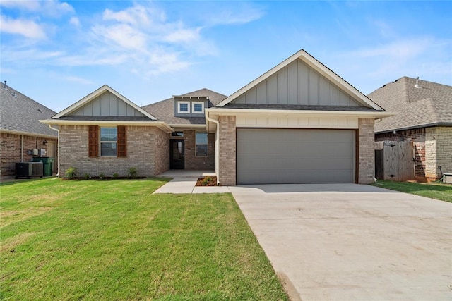 view of front of home with central AC unit, a garage, and a front yard