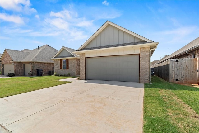 view of front facade featuring a front yard, central AC, and a garage