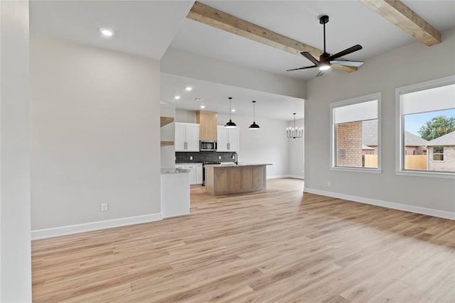 unfurnished living room featuring beam ceiling, light hardwood / wood-style flooring, ceiling fan with notable chandelier, and sink