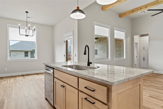 kitchen featuring pendant lighting, ceiling fan with notable chandelier, sink, and light brown cabinetry