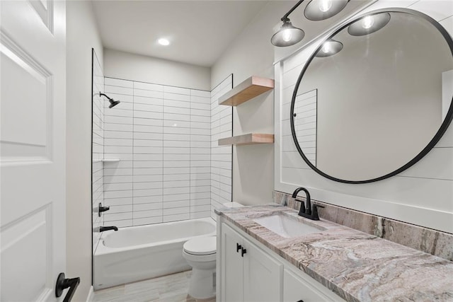 full bathroom with vanity, toilet, and tiled shower / bath