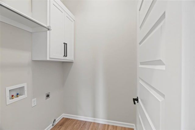 laundry room with hookup for an electric dryer, light hardwood / wood-style floors, cabinets, and hookup for a washing machine