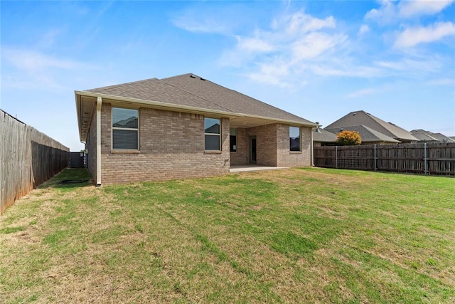 back of property featuring a yard and a patio