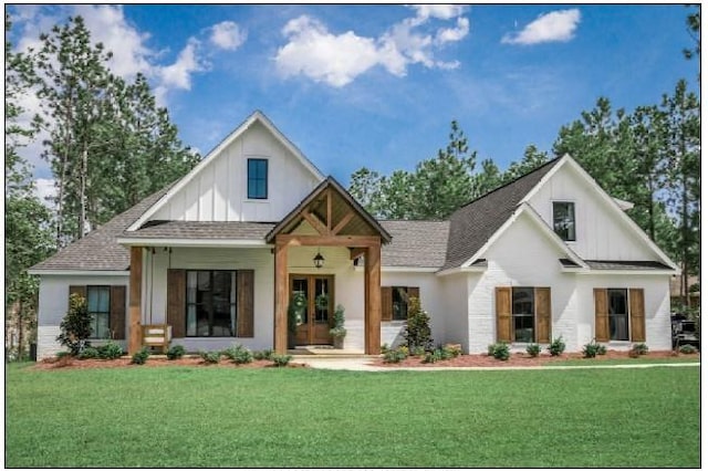 modern farmhouse with a front yard and french doors