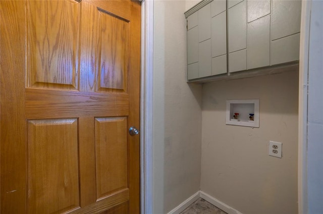 laundry area featuring washer hookup and cabinets