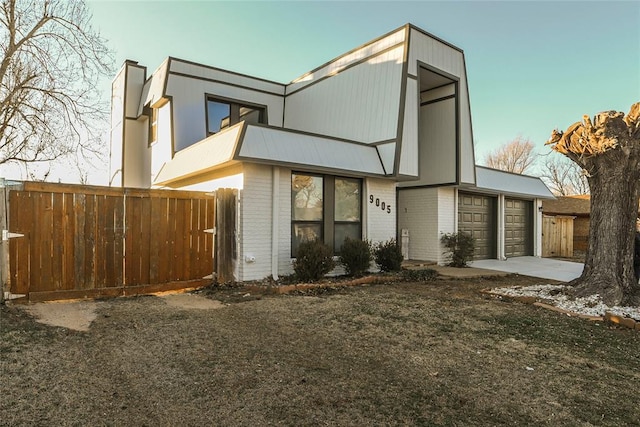 rear view of house featuring a garage