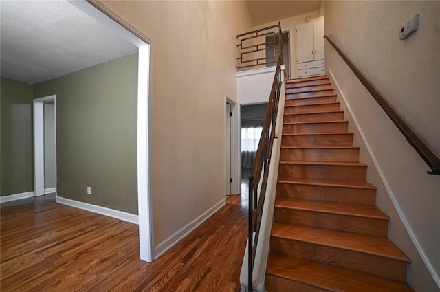 staircase with hardwood / wood-style floors