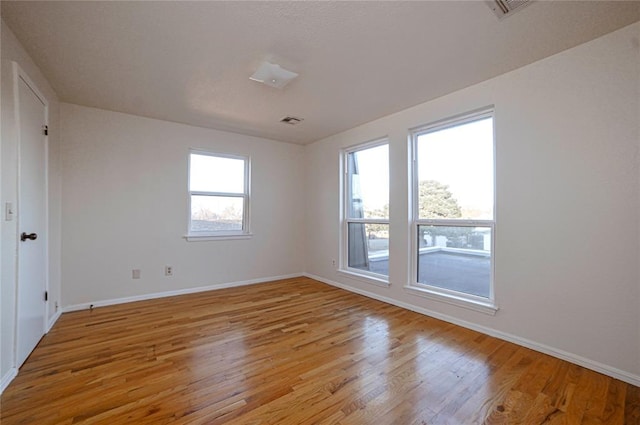 spare room with light hardwood / wood-style flooring