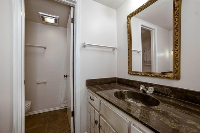 bathroom with tile patterned floors, vanity, and toilet