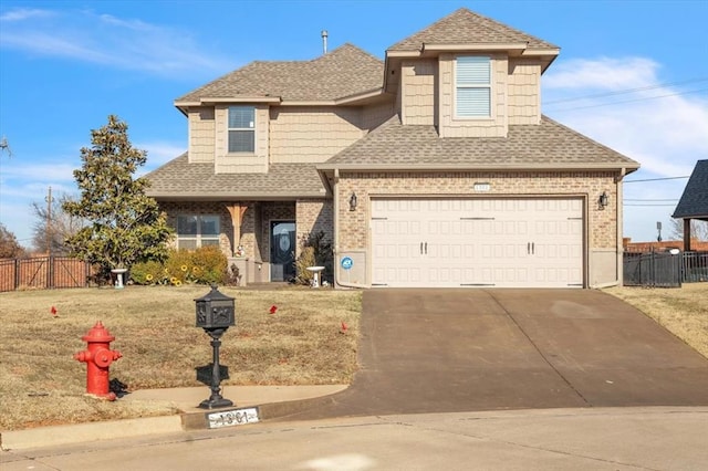 view of front of home featuring concrete driveway, brick siding, and fence