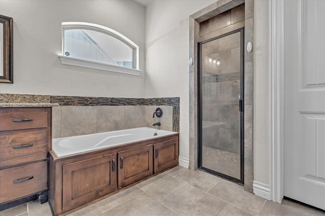 full bath with a garden tub, a shower stall, and tile patterned floors