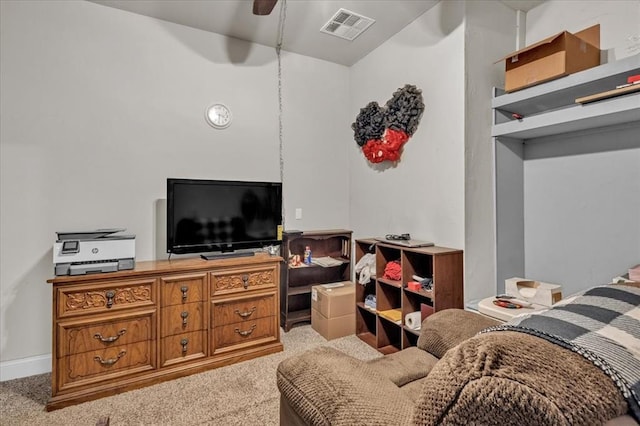 carpeted living room with ceiling fan, visible vents, and baseboards