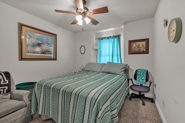 carpeted bedroom featuring a ceiling fan and baseboards