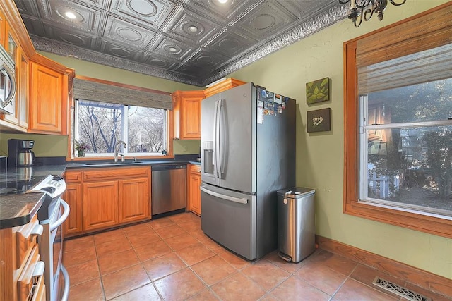 kitchen with sink, light tile patterned floors, and stainless steel appliances