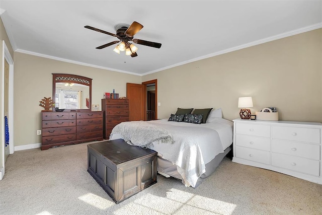 carpeted bedroom with ceiling fan and ornamental molding