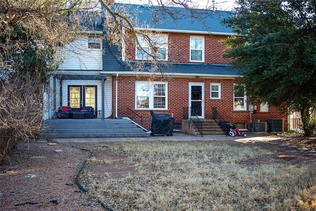 rear view of property featuring central AC