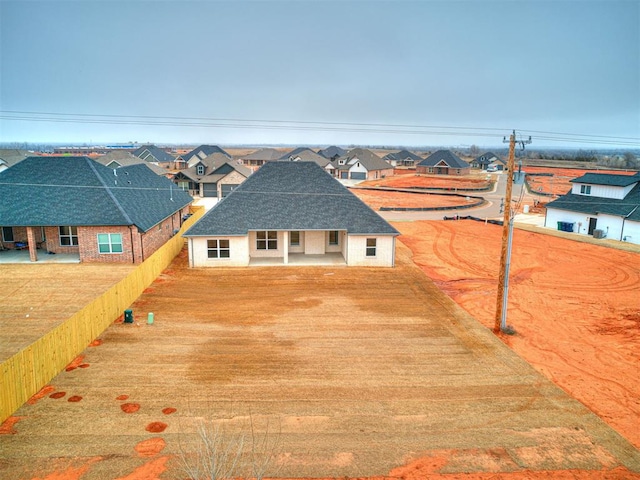 view of front of property with a residential view and fence