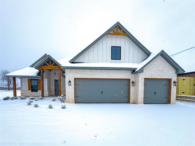 modern farmhouse style home with an attached garage, board and batten siding, and brick siding