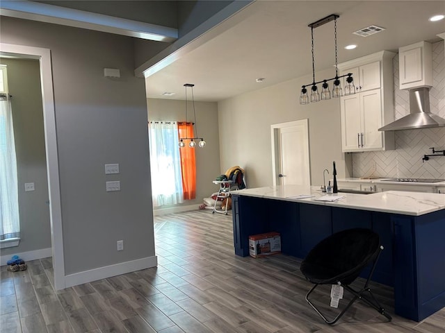 kitchen with decorative light fixtures, white cabinetry, dark hardwood / wood-style flooring, tasteful backsplash, and a kitchen breakfast bar