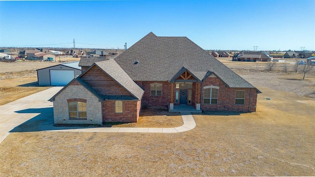 view of front of house featuring concrete driveway, brick siding, a front yard, and roof with shingles