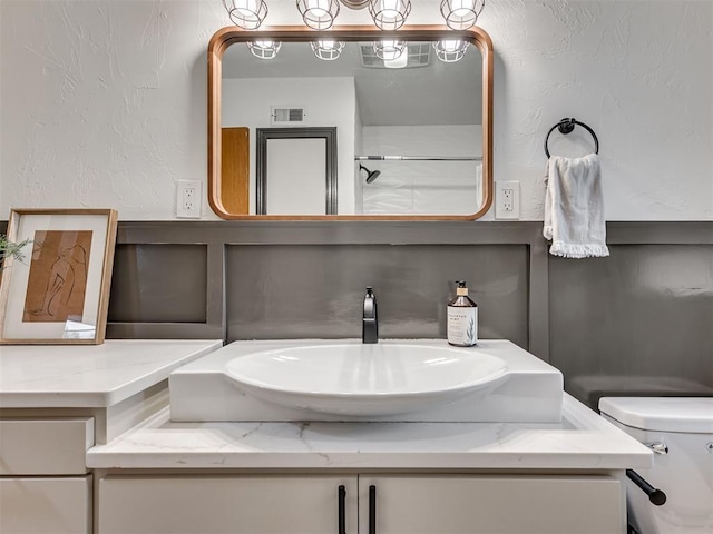 bathroom with vanity and toilet